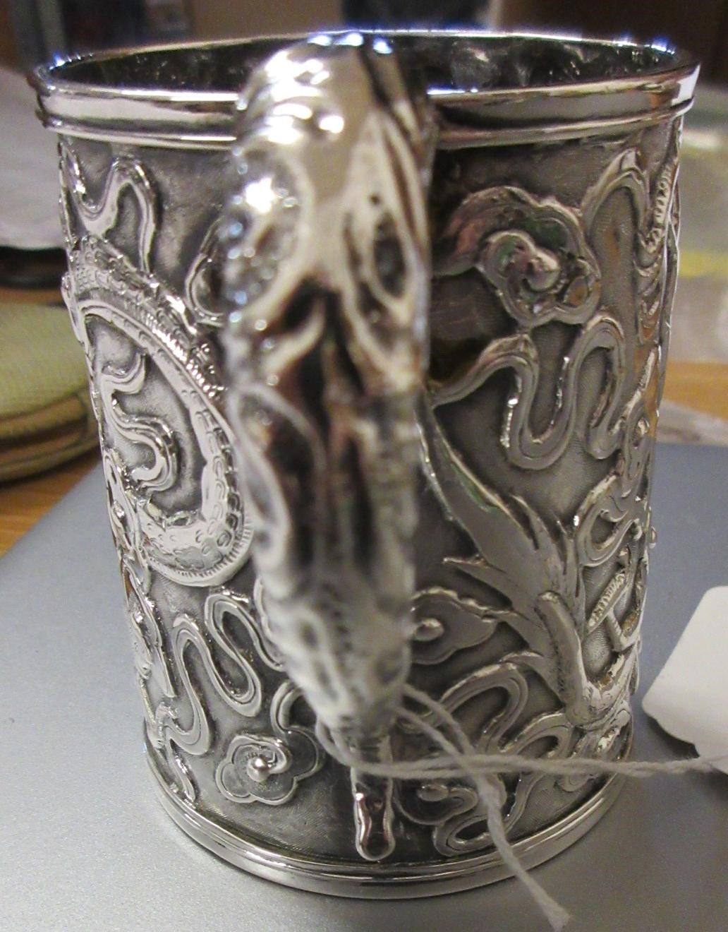 A CHINESE EXPORT SILVER CHRISTENING MUG by Kwong Man Shing (act.1875-1925) Image