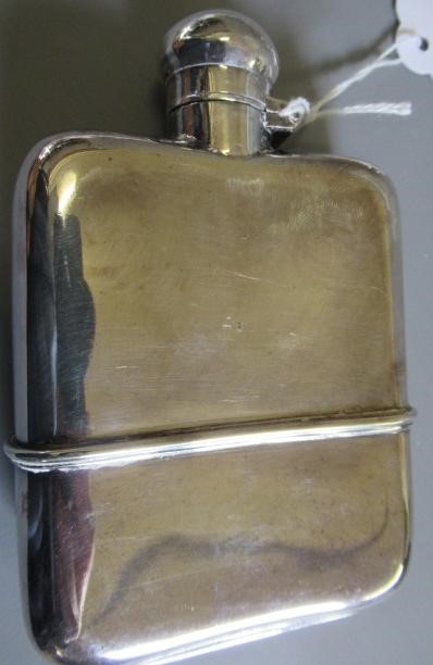 A SILVER HIP FLASK by G & J W Hawksley, Sheffield 1931, of plain rounded oblong form with pull-off Image
