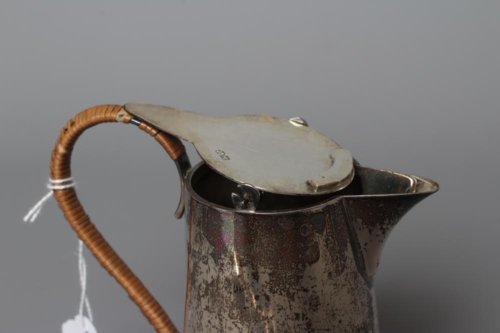 AN EDWARDIAN SILVER HOT MILK JUG by Barker Brothers Image