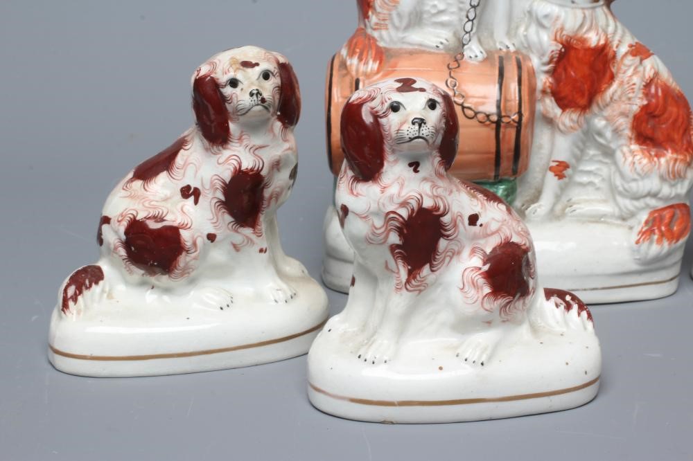 A COLLECTION OF VICTORIAN POTTERY SPANIELS comprising a pair of spaniels with a barrel Image