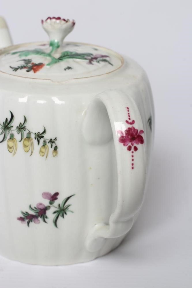 A WORCESTER PORCELAIN RIBBED BARREL TEAPOT AND COVER, c.1775, painted in colours with bouquets and Image