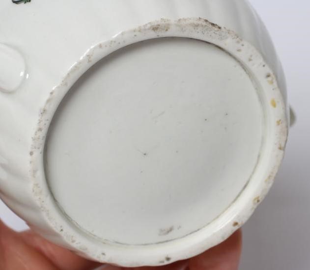 A WORCESTER PORCELAIN RIBBED BARREL TEAPOT AND COVER, c.1775, painted in colours with bouquets and Image