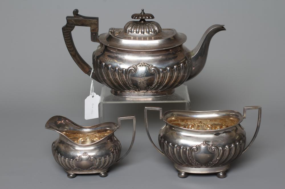 AN EDWARDIAN SILVER MATCHED THREE PIECE TEA SERVICE by John Round & Son Ltd. Image