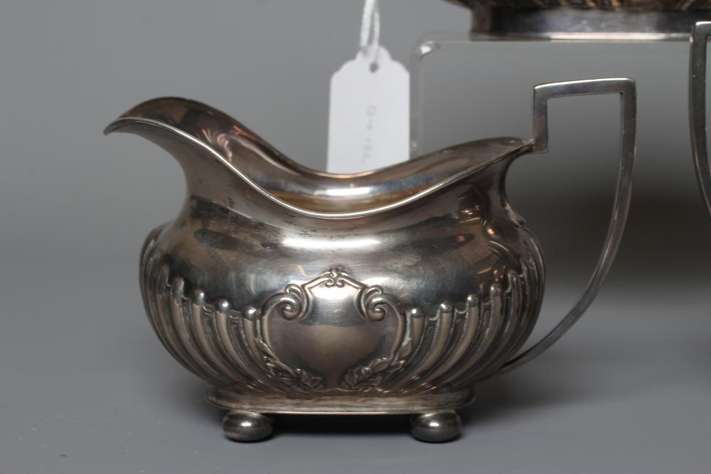 AN EDWARDIAN SILVER MATCHED THREE PIECE TEA SERVICE by John Round & Son Ltd. Image