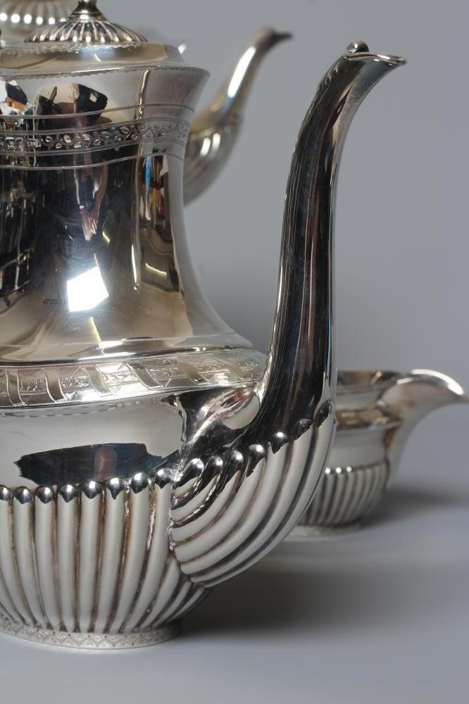 A COMPOSITE LATE VICTORIAN/EDWARDIAN SILVER FOUR PIECE TEA AND COFFEE SERVICE by Walker & Hall Image