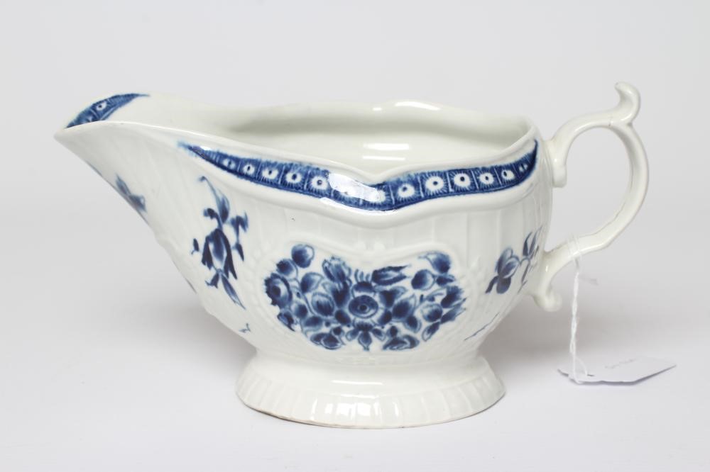 A WORCESTER PORCELAIN STRAP FLUTE FLORAL SAUCEBOAT, c.1780, of pleat moulded shaped oval form, Image