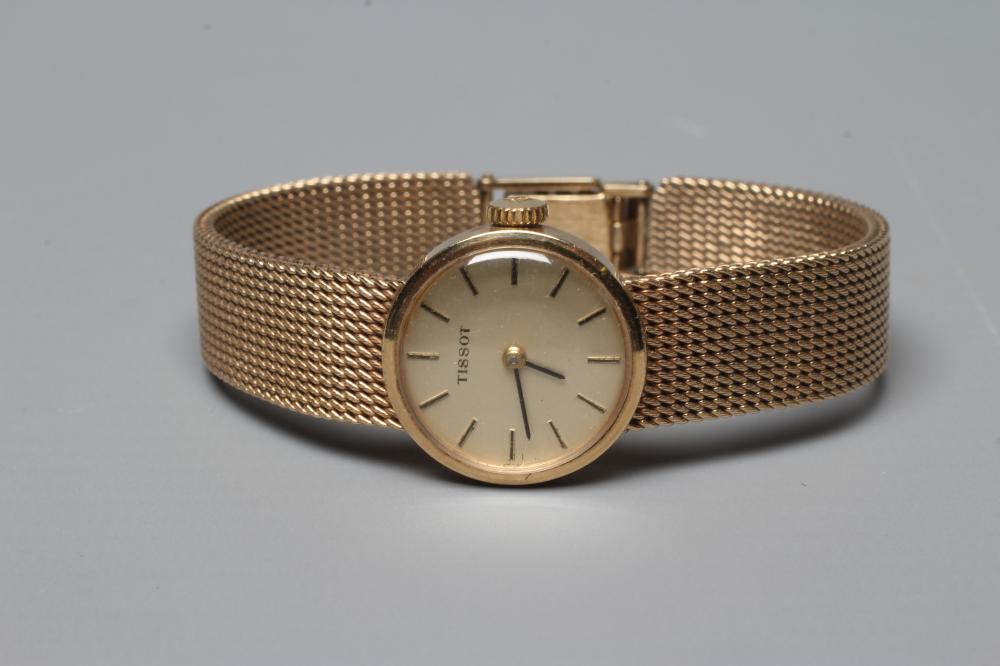 A LADY'S 9CT GOLD TISSOT WRISTWATCH, the champagne dial with applied metal batons, the unnumbered Image