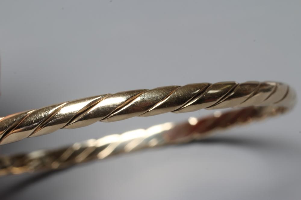 A 9CT GOLD PLAIN TWIST BANGLE, Sheffield 1987, sponsor MJM, 14.7g Image