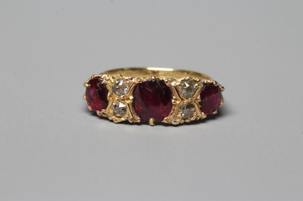 A LATE VICTORIAN THREE STONE RUBY RING Image
