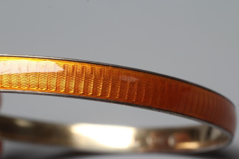 A NORWEGIAN SILVER GILT BANGLE BY MARIUS HAMMER with orange guilloche enamelling, stamped 925S, MH Image