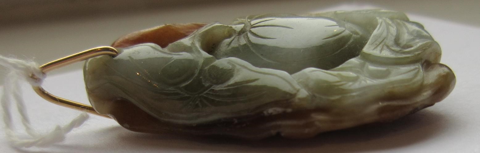 A CHINESE JADE PENDANT, one side carved as a hare (?) beside a flower, the other with a persimmon, Image