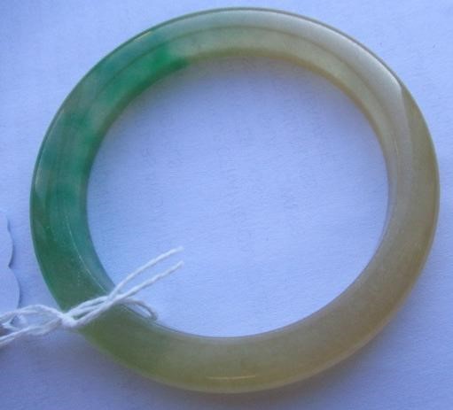 A CHINESE POLISHED JADE BANGLE of D form, 37g, together with a silver mounted jade Shou pendant, Image