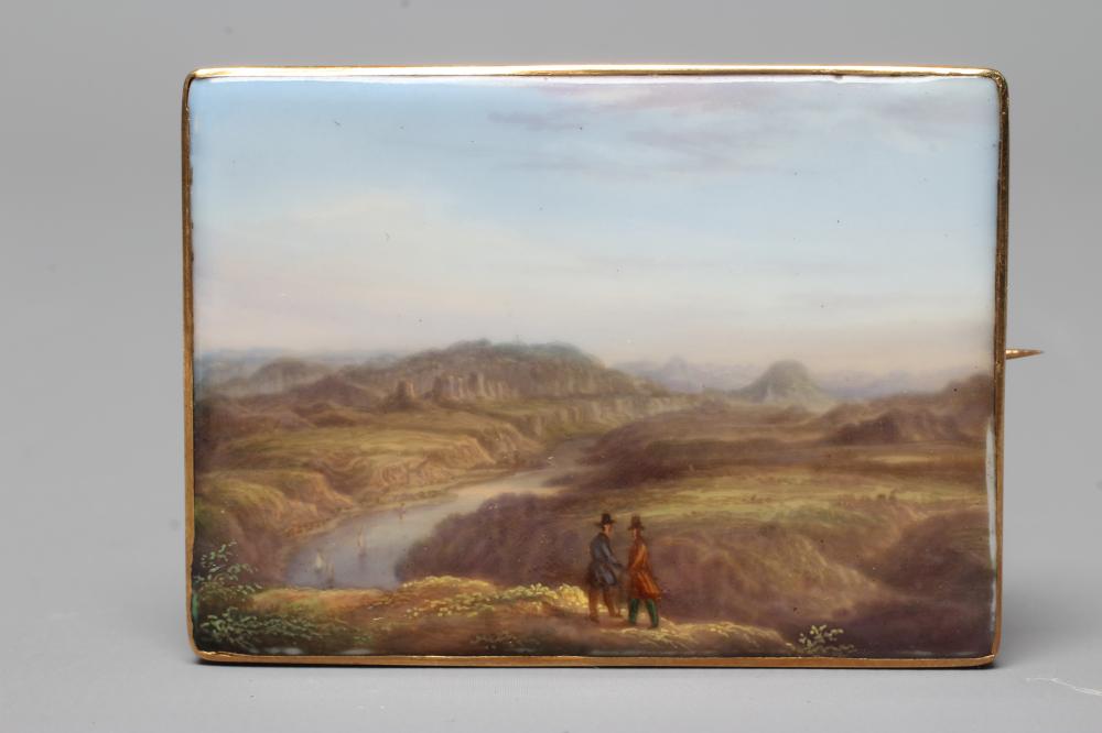 A CONTINENTAL PORCELAIN OBLONG PLAQUE BROOCH painted in polychrome enamels with an extensive lake Image