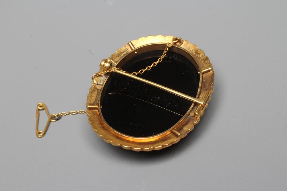 A JASPER CAMEO carved with the head and shoulders of a young girl wearing a wreath in her hair on a Image