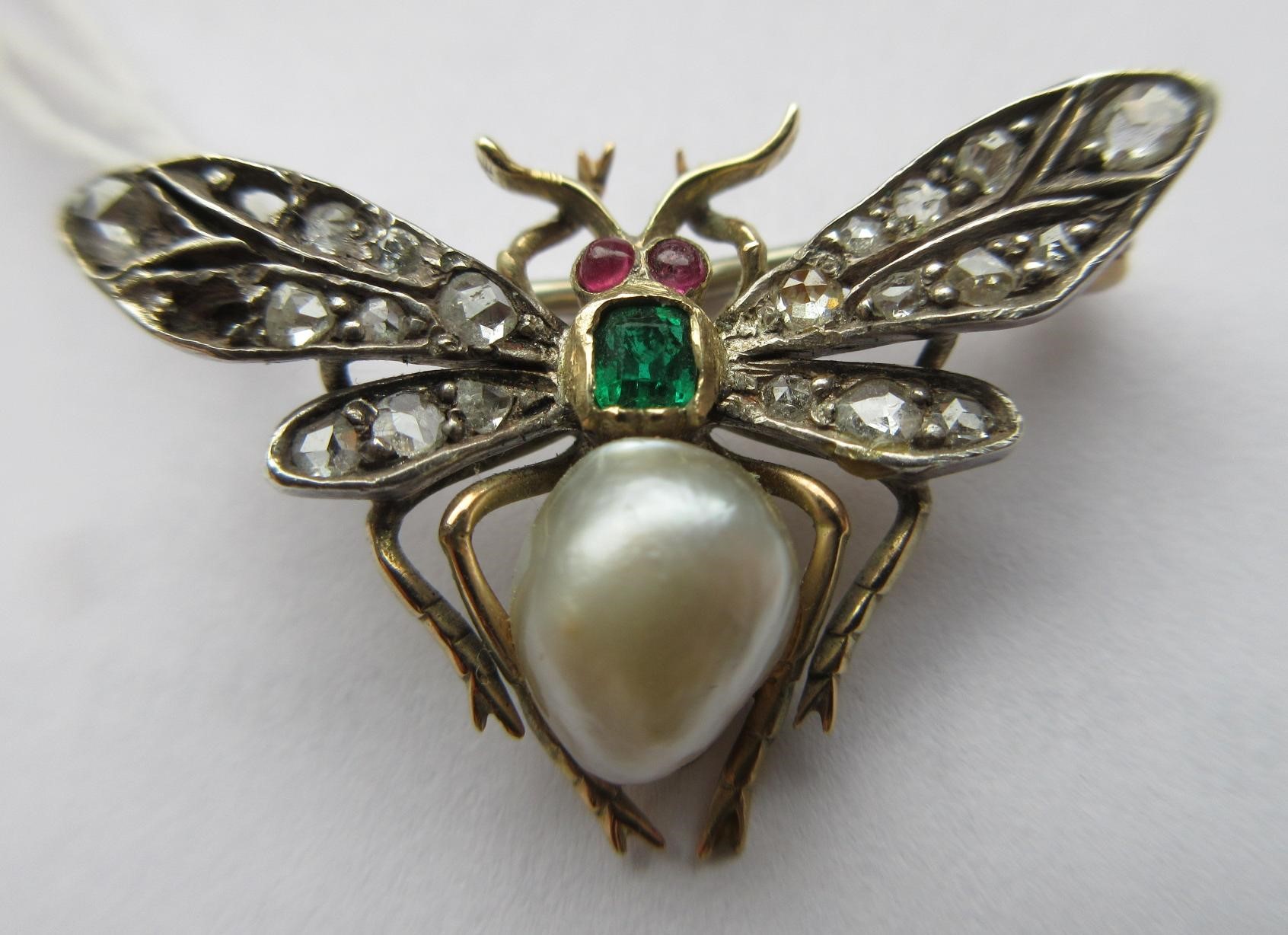 A VICTORIAN INSECT BROOCH with two ruby cabochon eyes, square cut emerald thorax and blister pearl Image