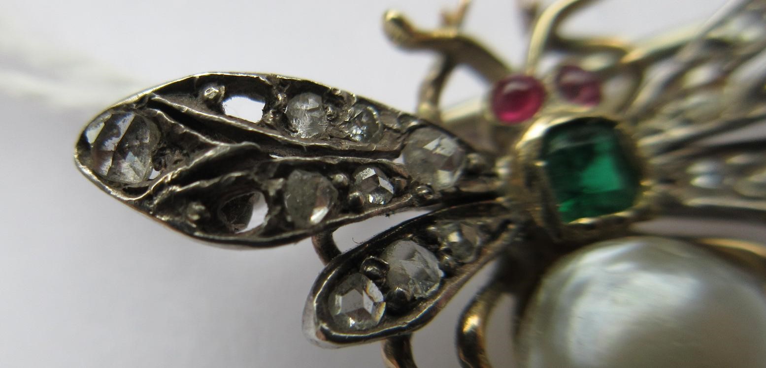 A VICTORIAN INSECT BROOCH with two ruby cabochon eyes, square cut emerald thorax and blister pearl Image