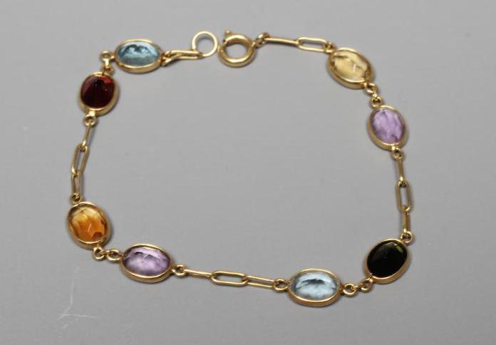 A MULTI-GEM BRACELET, the four pairs of facet cut coloured stones including garnet, aquamarine and Image