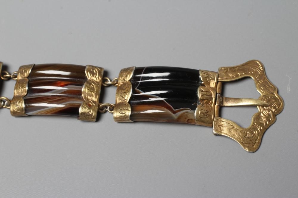 A VICTORIAN SCOTTISH POLISHED AGATE BRACELET, the five ribbed panels with engraved gilt metal mounts Image