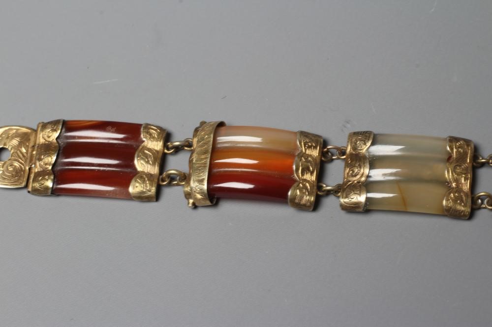 A VICTORIAN SCOTTISH POLISHED AGATE BRACELET, the five ribbed panels with engraved gilt metal mounts Image