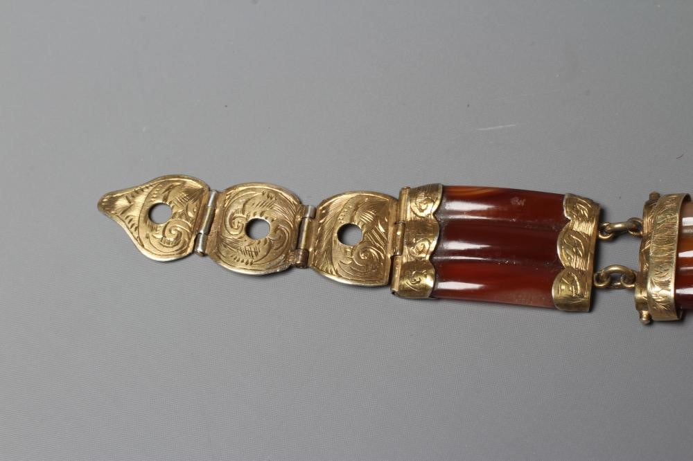A VICTORIAN SCOTTISH POLISHED AGATE BRACELET, the five ribbed panels with engraved gilt metal mounts Image