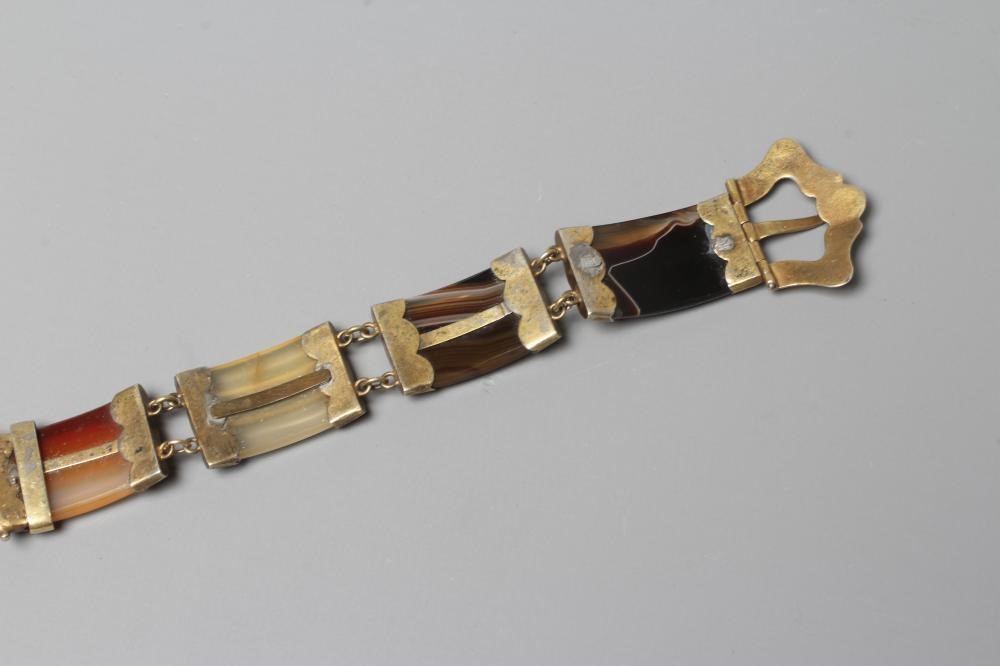 A VICTORIAN SCOTTISH POLISHED AGATE BRACELET, the five ribbed panels with engraved gilt metal mounts Image