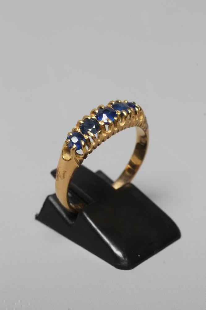 A MID VICTORIAN FIVE STONE SAPPHIRE RING, the graduated facet cut stones claw set to a plain 18ct Image
