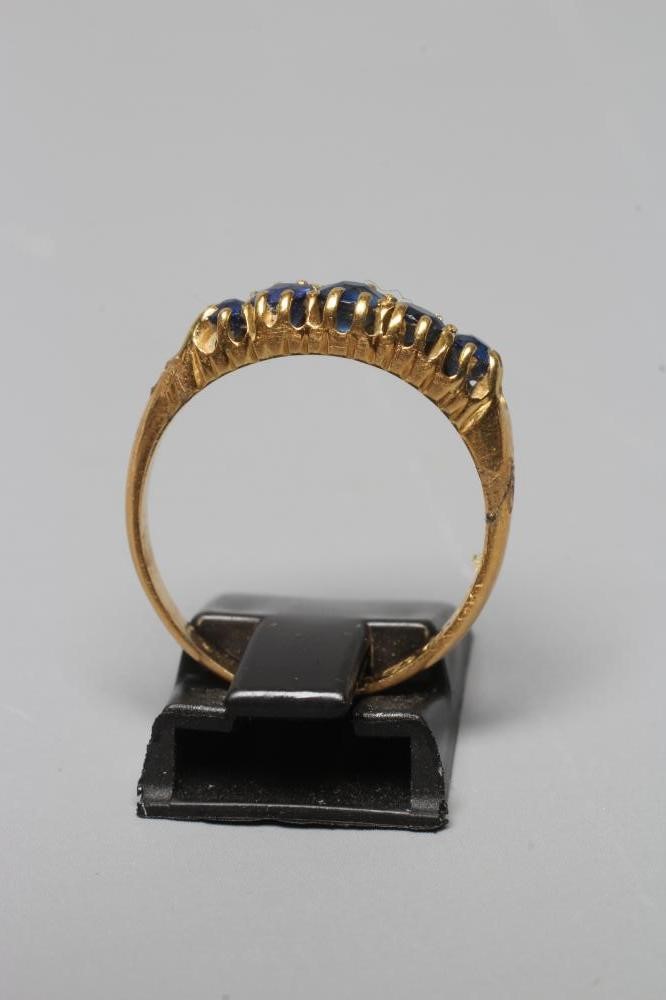 A MID VICTORIAN FIVE STONE SAPPHIRE RING, the graduated facet cut stones claw set to a plain 18ct Image
