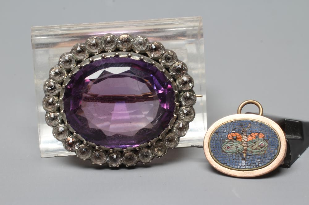 A VICTORIAN MICRO-MOSAIC OVAL MINIATURE BROOCH centred by a butterfly on a black ground Image