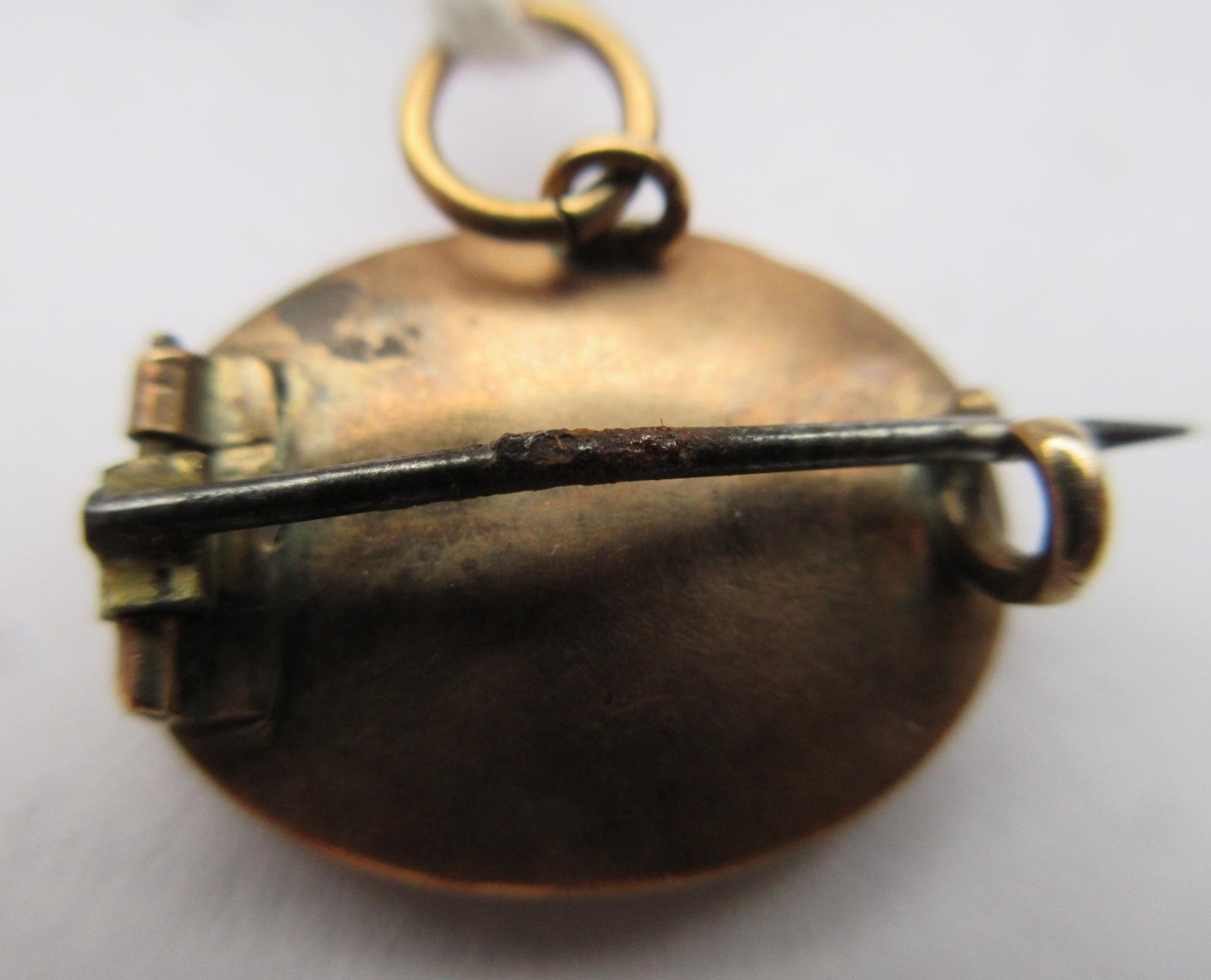 A VICTORIAN MICRO-MOSAIC OVAL MINIATURE BROOCH centred by a butterfly on a black ground Image