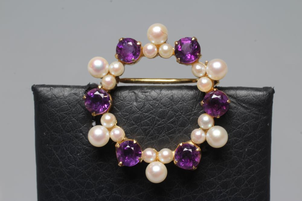 AN AMETHYST AND CULTURED PEARL CIRCLET BROOCH, the six facet cut amethysts claw set with six Image