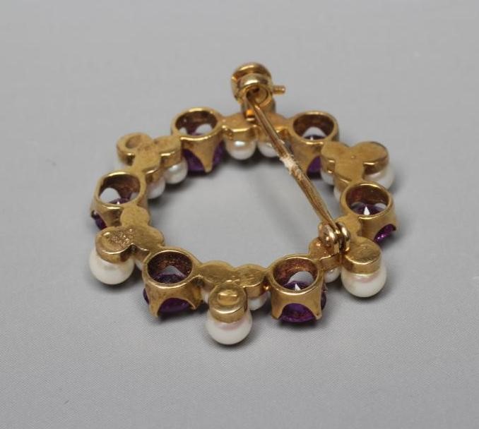 AN AMETHYST AND CULTURED PEARL CIRCLET BROOCH, the six facet cut amethysts claw set with six Image