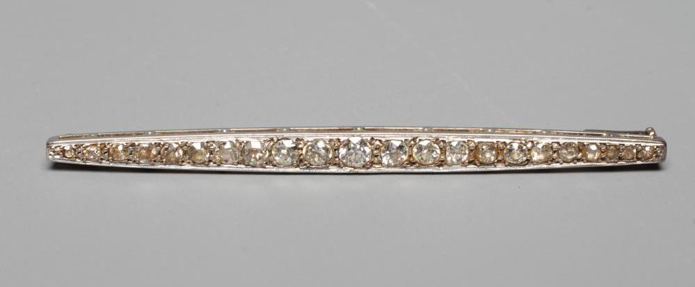 A DIAMOND BROOCH, the shaped bar point set with twenty-two old cut stones to an unmarked frame (Est. Image