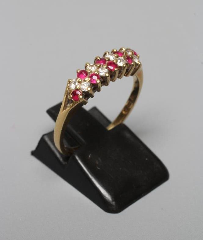 A RUBY AND DIAMOND HALF HOOP ETERNITY RING Image
