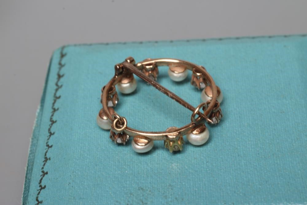 A LATE VICTORIAN DIAMOND AND PEARL CIRCLET BROOCH Image