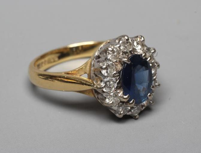 A SAPPHIRE AND DIAMOND CLUSTER RING Image