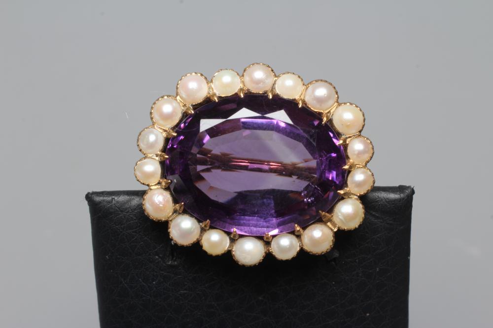 A LATE VICTORIAN AMETHYST AND PEARL BROOCH, the oval facet cut amethyst claw set to a border of Image