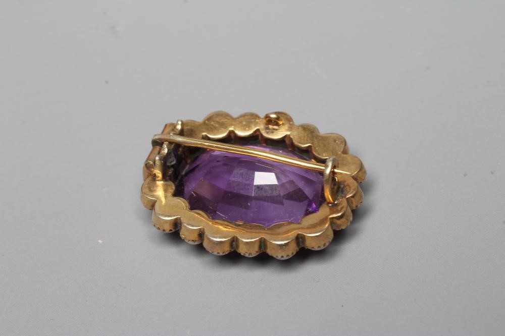 A LATE VICTORIAN AMETHYST AND PEARL BROOCH, the oval facet cut amethyst claw set to a border of Image