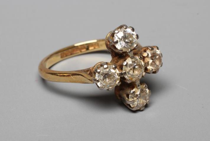 A FIVE STONE DIAMOND RING, the old brilliant cut stones each of approximately 0.25cts, claw set to a Image