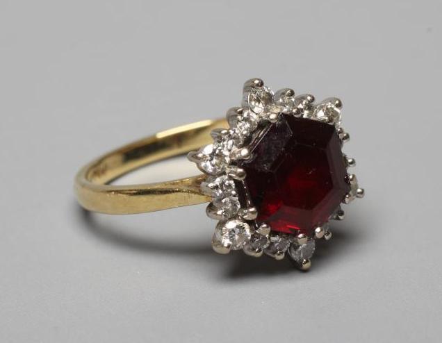 A GARNET AND DIAMOND CLUSTER RING Image
