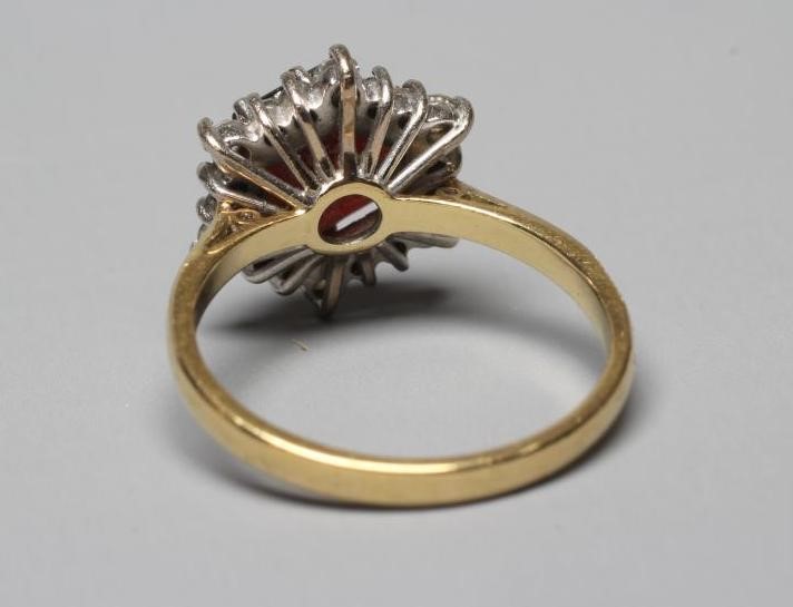 A GARNET AND DIAMOND CLUSTER RING Image