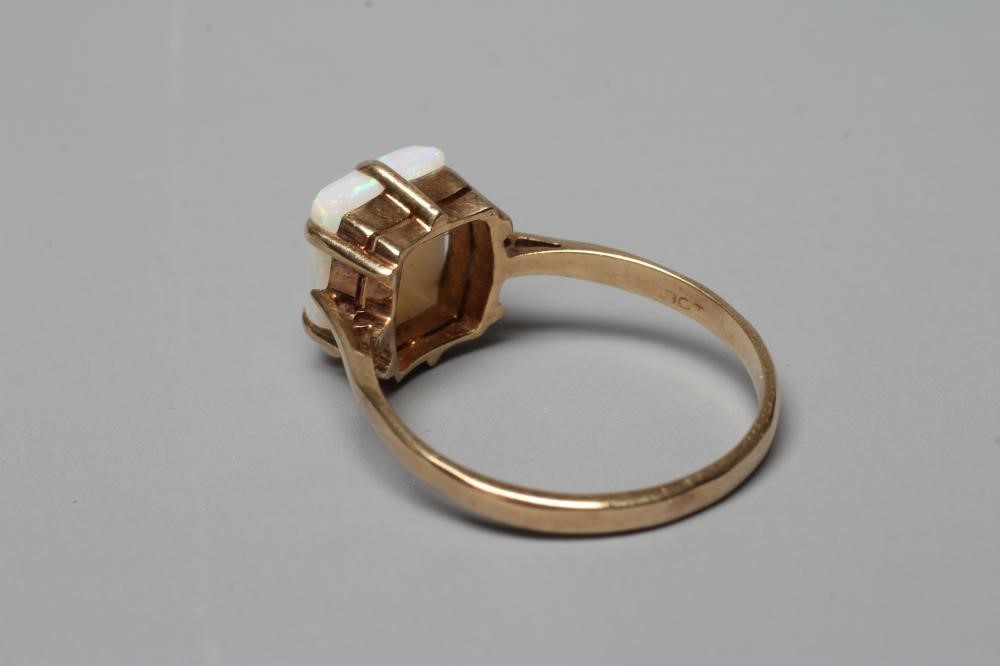 AN OPAL DRESS RING, the square cut cabochon stone claw set to a plain 9ct gold shank, Birmingham Image