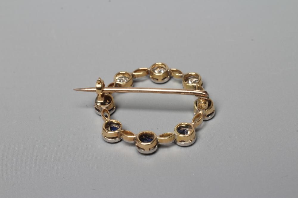 A SAPPHIRE AND DIAMOND CIRCLET BROOCH, the eight roundels each set with a marquise cut sapphire and Image