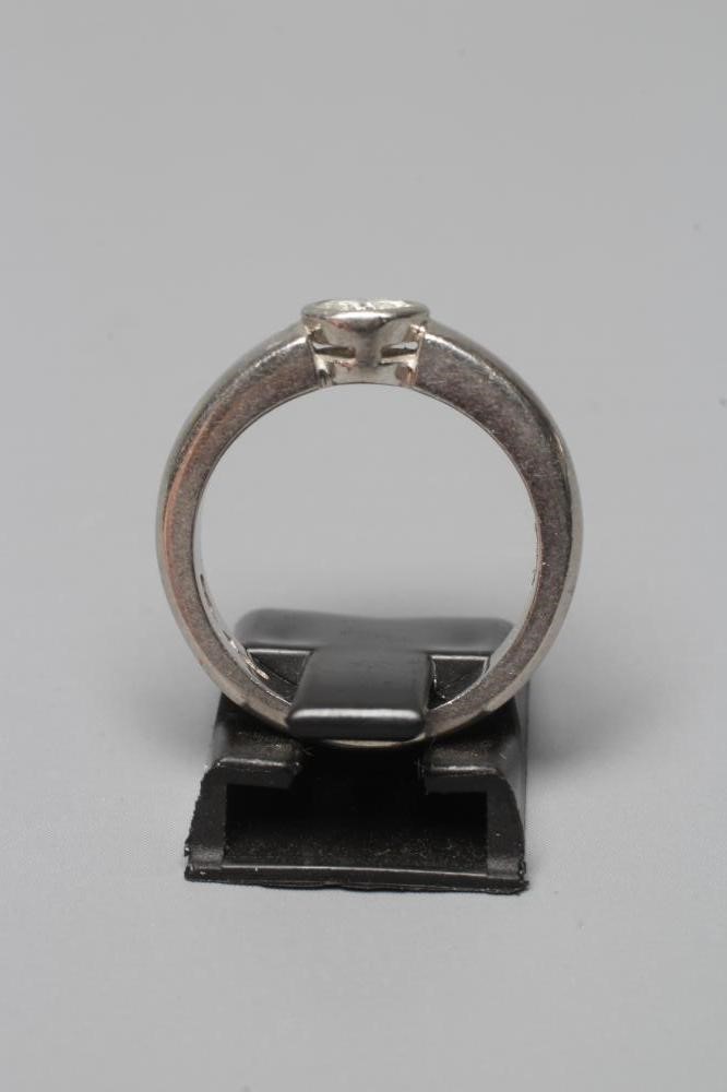 A SOLITAIRE DIAMOND RING, the brilliant cut stone of approximately 0.5cts in rub-over setting to a Image