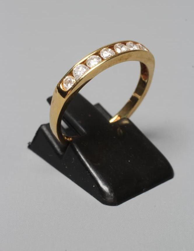 A SEVEN STONE DIAMOND HALF HOOP ETERNITY RING, the brilliant cut stones totalling 0.5cts, channel Image