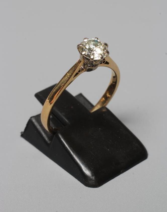 A SOLITAIRE DIAMOND RING, the brilliant cut stone of approximately 0.6cts claw set to a plain Image