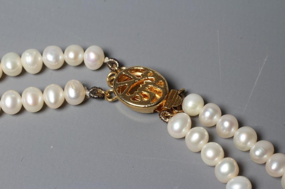 A DOUBLE STRAND FRESHWATER PEARL NECKLACE with gilt metal clasp (Est. plus 24% premium inc. VAT) Image