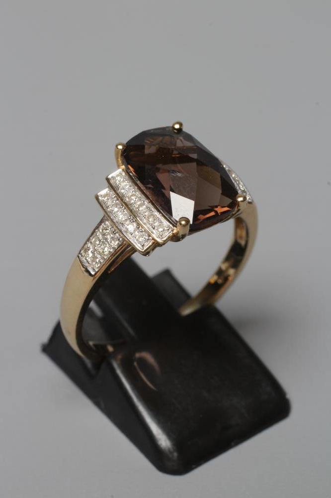 A DRESS RING, the oblong facet cut smoky quartz claw set to stepped shoulders point set with Image