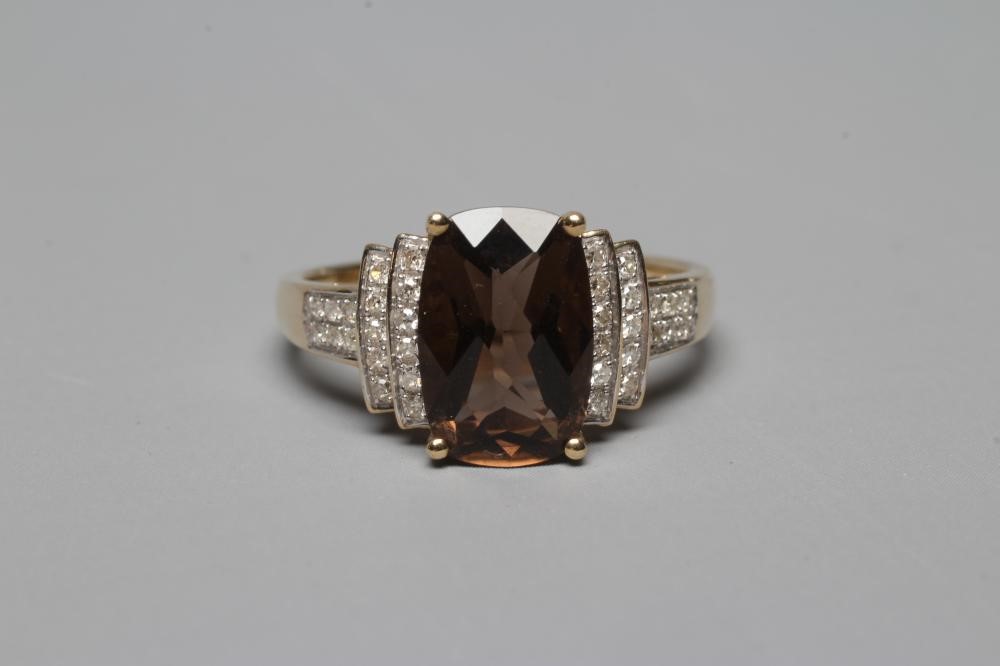 A DRESS RING, the oblong facet cut smoky quartz claw set to stepped shoulders point set with Image
