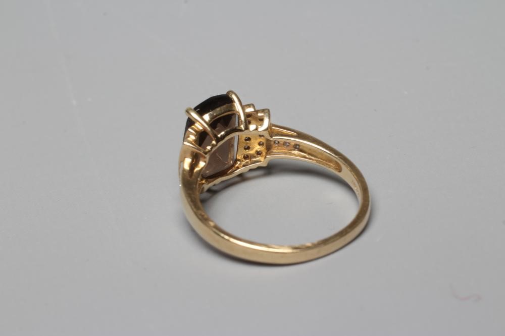 A DRESS RING, the oblong facet cut smoky quartz claw set to stepped shoulders point set with Image