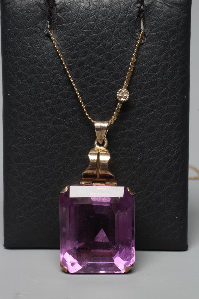 AN AMETHYST PENDANT, the oblong facet cut stone claw set to a plain unmarked frame with hinged bale, Image